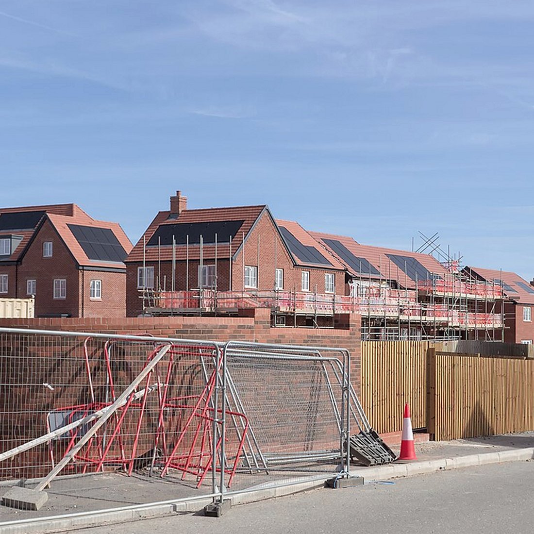 Red-brick houses with scaffold still up on the row